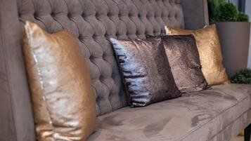 A tufted sofa with three cushions.