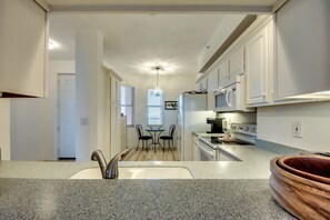 Enjoy cooking and dining in this well-equipped kitchen with a granite countertop and stainless steel appliances.