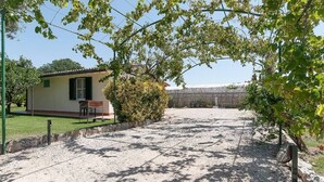 A house with a patio, a small garden, and a gravel area. - Villa LA CASETTA for 4-6 persons - with jacuzi (San Felice Circeo)