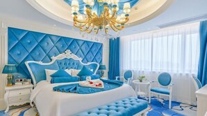 Une chambre à coucher luxueuse, dotée d’un grand lit, d’un lustre et offrant une vue sur l’extérieur.