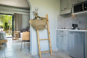 A modern kitchen with a wooden ladder, a microwave, and a dishwasher. - Avithos Resort (Kefalonia)