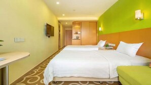 A hotel room with two beds, a small desk, and a television on the wall. - Guang Xin Hotel (Shenzhen)