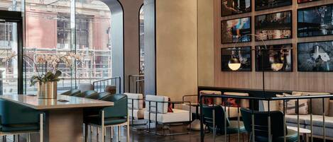 A modern interior with a bar area, seating, and artwork on the walls.