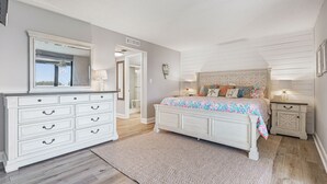 A bedroom with a large bed, a dresser, and a mirror. - 🌺Remodeled Coastal Retreat With Beach Gear 🐶 Loggerhead Cay 463🐠 (Sanibel)