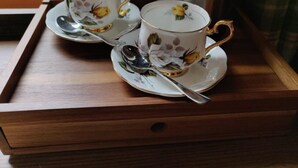 A tray with two cups and a spoon on a wooden surface. - Rhododendron Suite -With views of the rhododendron trees on the hillside (Inverness)