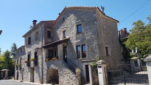 A stone building with a sign indicating it is a restaurant.