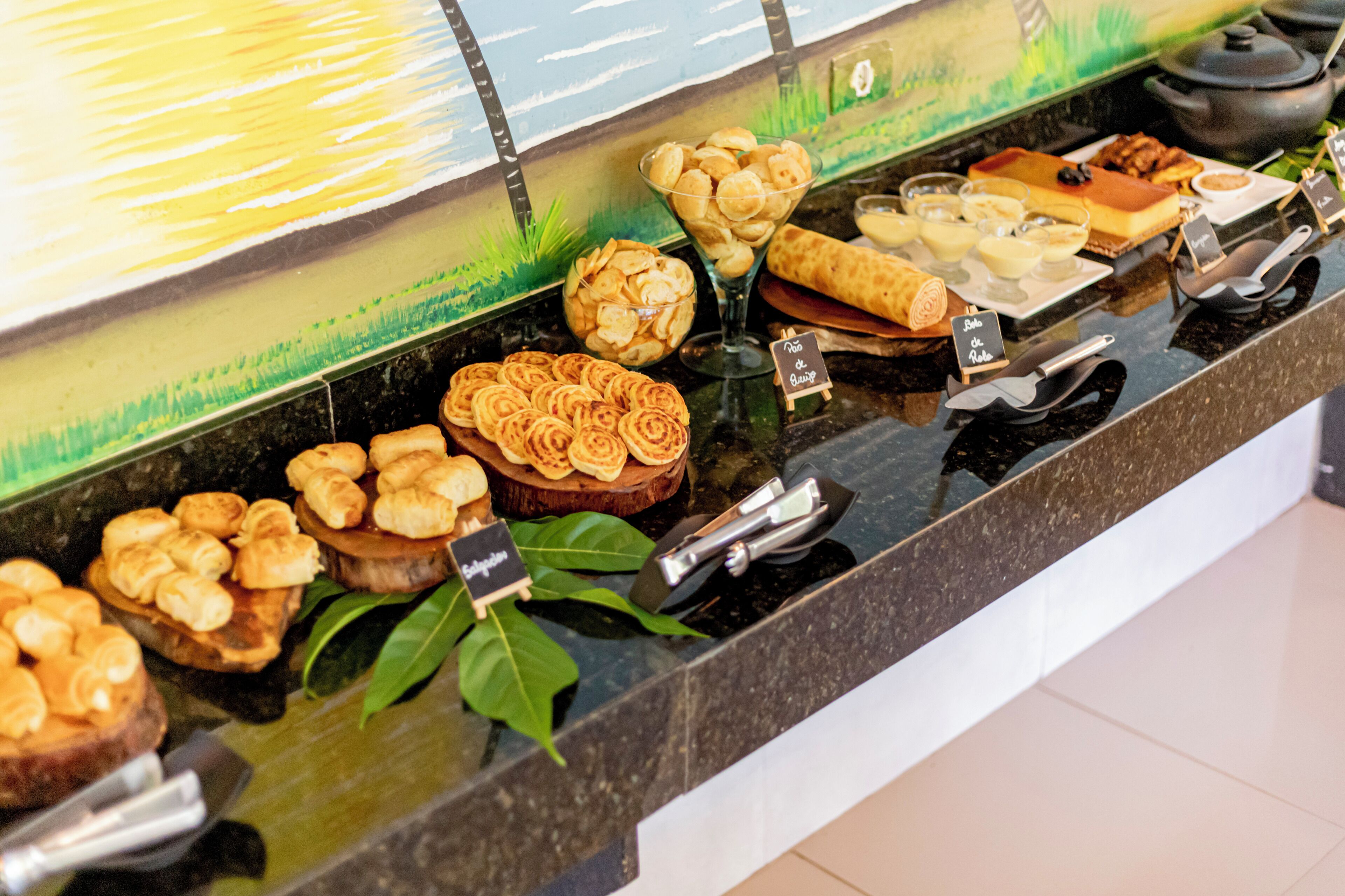 A buffet with various pastries and desserts.