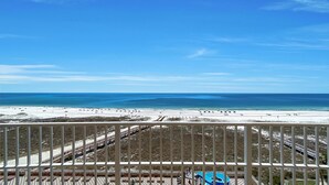 A beach view from a balcony with a railing, a pool, and a beach area with people and beach chairs. - Beachfront,POB II #601 Parking Level,4 Bedroom, Immaculate, Great Views
 (Orange Beach)