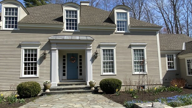 A two-story house with a stone front walkway, a blue door, and a wreath. - Spacious Kennebunkport River property, family/pet friendly, 2 miles to beaches (Kennebunk)