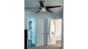 A bedroom with a ceiling fan, white doors, and a bed. - Beautiful Paris in El Paso Home❤️ 3BR Near Ft Bliss (El Paso)