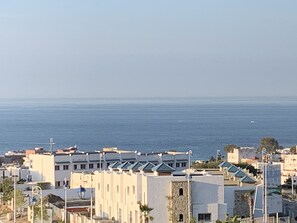A coastal town with buildings featuring flat roofs and a clear view of the sea. - Apartment - Summer Private Residence with Swimming Pools (M'diq)