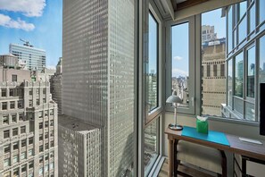 A high-rise office with a large window offering a city view.