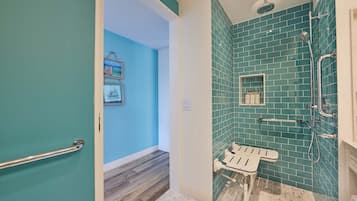 A bathroom with a shower, a toilet, and a sink.