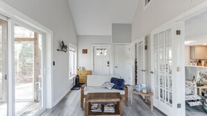 Ein geräumiger Flur mit einer Holzbank, einem kleinen Tisch und einer Tür zum Küchenbereich.
