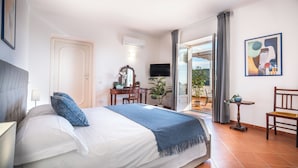 A hotel room with a bed, a desk, a television, and a balcony with a view. - Villa Dei Golfi , Panorama, Privacy and Quiet (Campania)