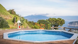 A hot tub on a wooden deck with a view of a mountainous landscape and the sea. - Villa Dei Golfi , Panorama, Privacy and Quiet (Campania)