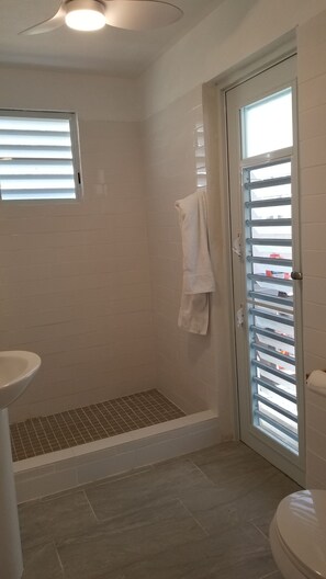 Shower, hair dryer, towels, toilet paper
