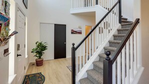 A staircase with white railings and black balusters, leading to an upper floor. - Spacious Thornton Home: 15 Mi to Downtown Denver! (Thornton)