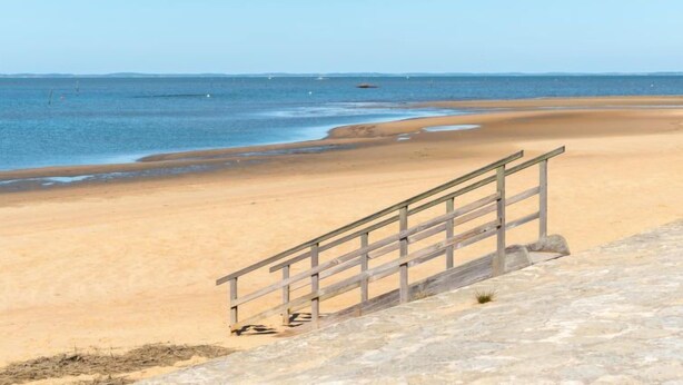 A beach with a wooden staircase leading down to the sand. - L'Albizia by Interhome (Gujan-Mestras)