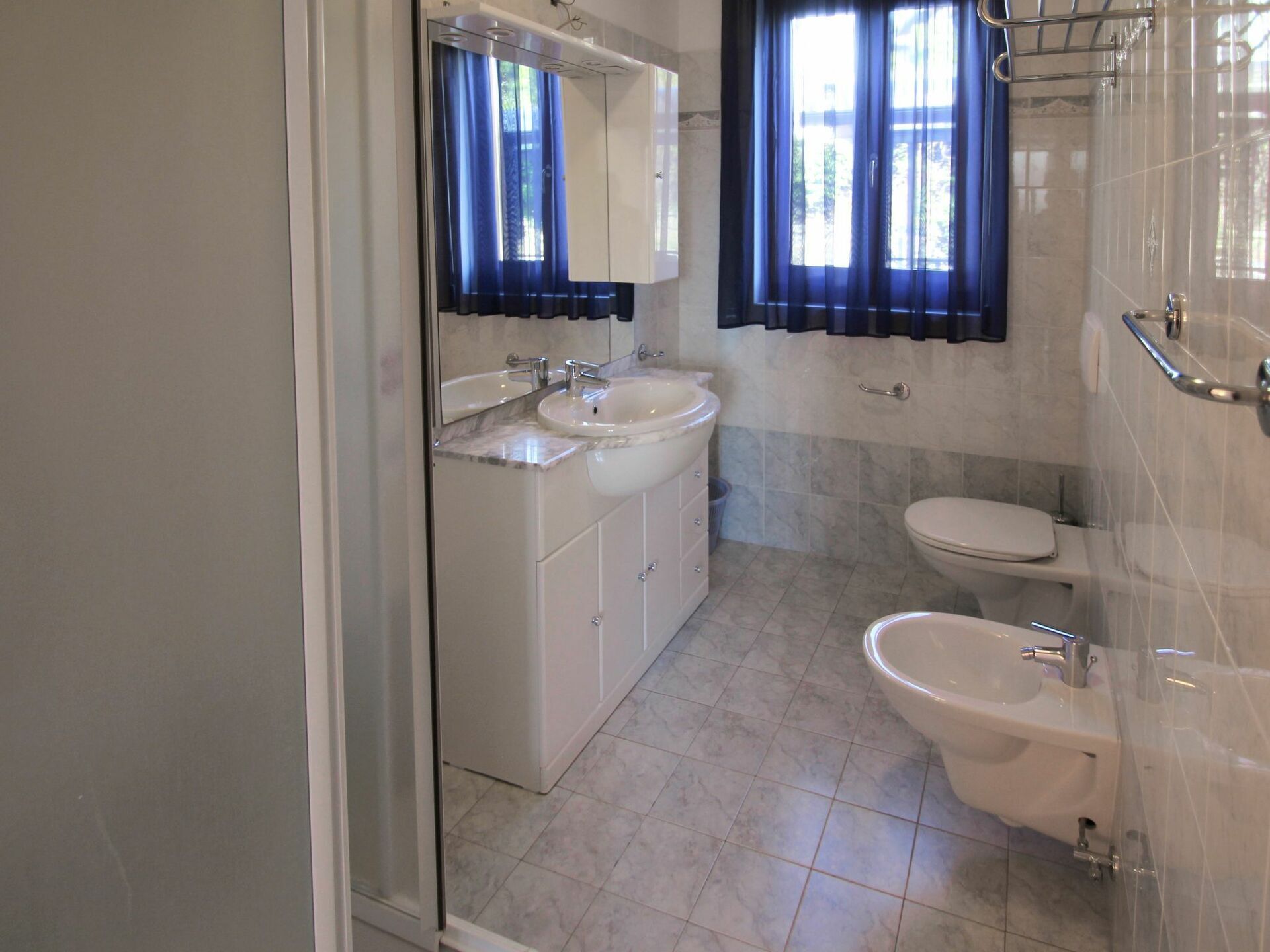 A bathroom with a sink, mirror, and toilet.