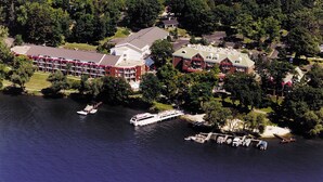 An aerial view of a hotel with multiple buildings, a dock with boats, and a marina. - Charming guest house on 1.5 acre lake front property (Green Lake)