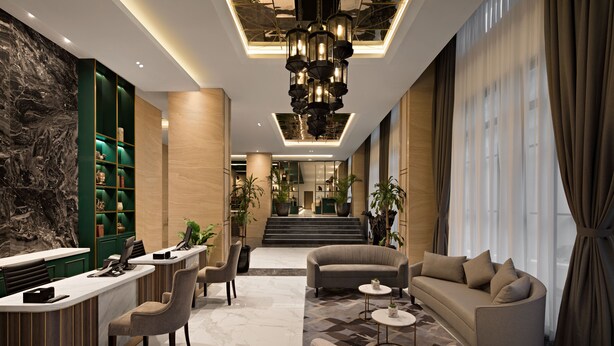 A modern lobby with a reception desk, seating area, and a staircase leading to an upper floor. - Sutasoma Hotel at The Tribrata Dharmawangsa (Jakarta)