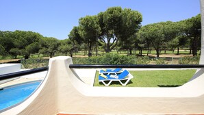A poolside area with a clear view of the pool, a lounge chair, and a grassy lawn. - Portuguese Rustic Style Villa With Private Pool (Loulé)