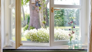 A window with a view of a tree and a garden. - Sprawling Farmhouse in Baarlo With Hot Tub, Private Garden (Baarlo)