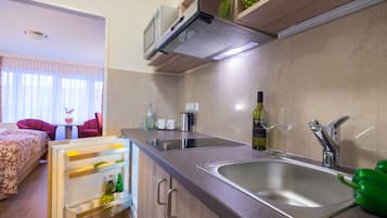 Fridge, microwave, coffee/tea maker, cookware/dishes/utensils