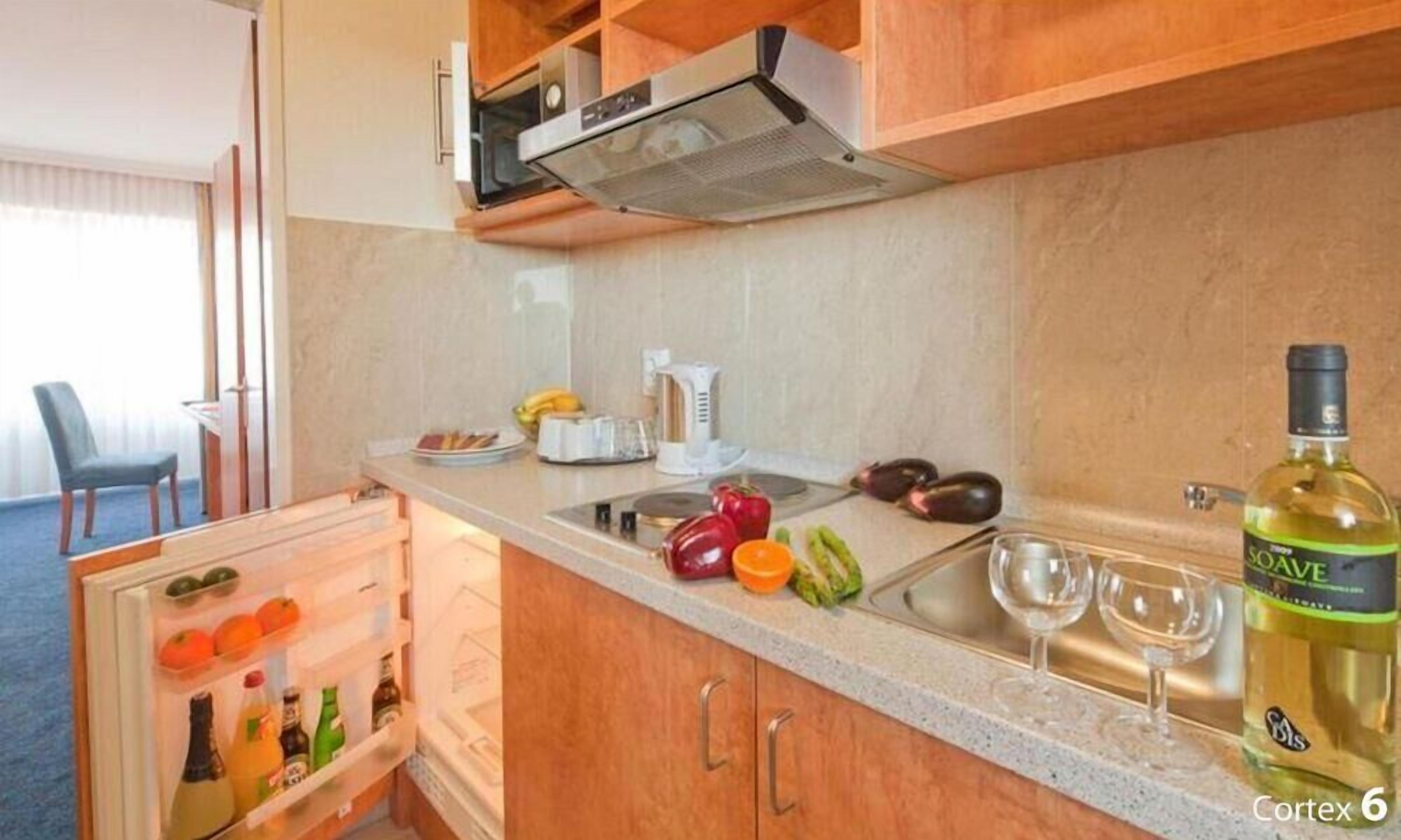 Fridge, microwave, coffee/tea maker, cookware/dishes/utensils