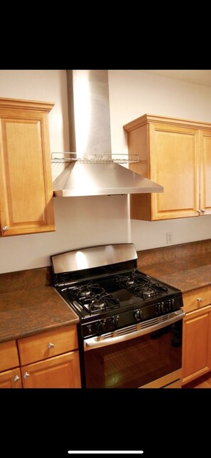 Enjoy cooking in this well-equipped kitchen with a stove top oven and range hood.
