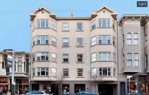 Stylish building with a blend of traditional and modern architecture, featuring a central section and two wings.