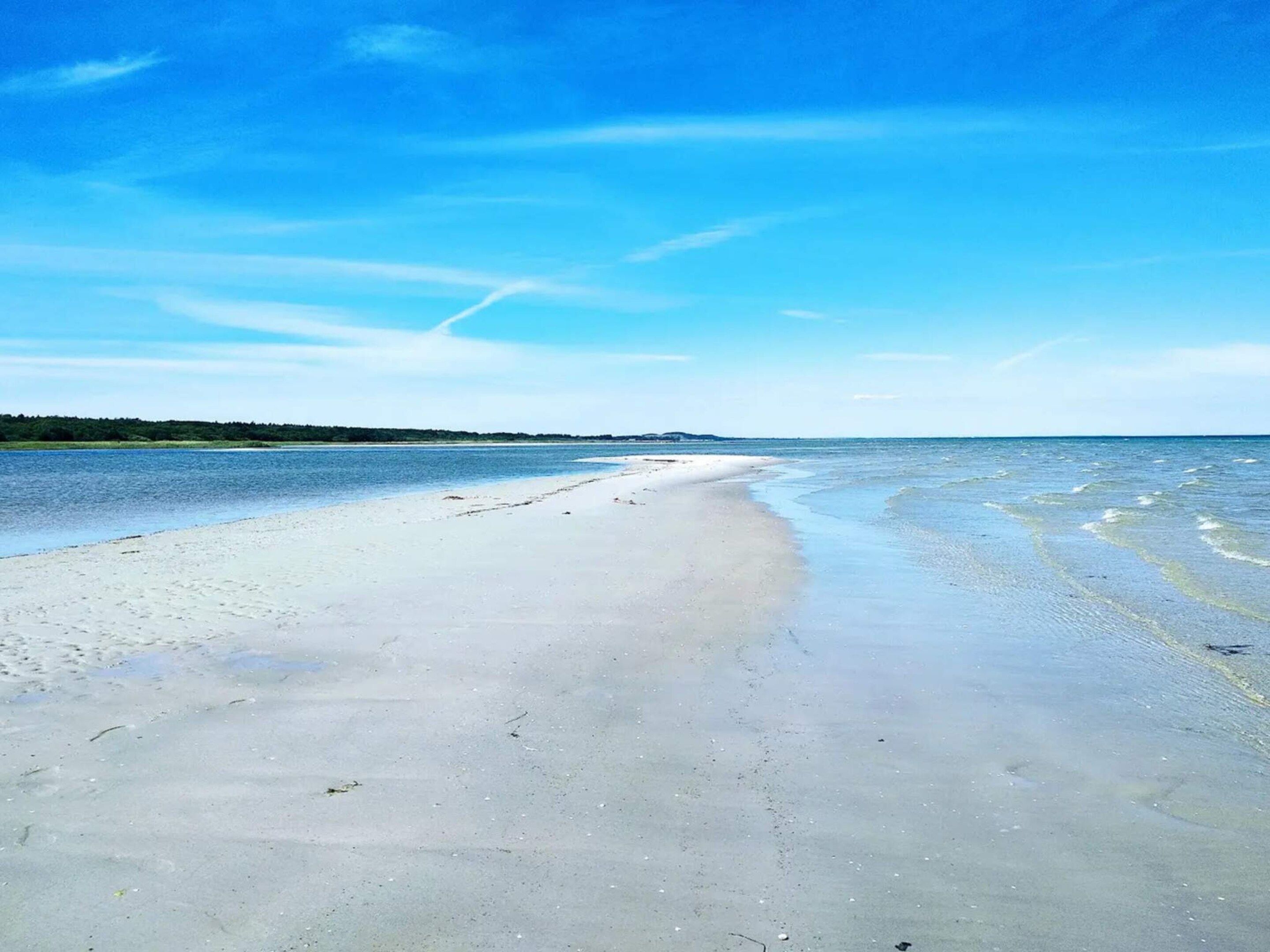 A beach with clear skies and calm waters.
