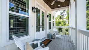 A covered porch with white railings, a ceiling fan, and a bench. - New Home South of 30A! 6 Seater Cart! 4 Bikes! - Three Little Birds at Blue Mountain Beach on 30A (Santa Rosa Beach)