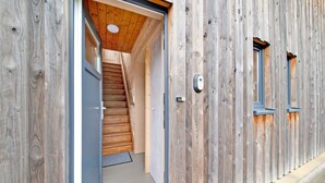A wooden exterior with a door leading to a staircase and a small window. - Charming Holiday Home in Stavelot With a Garden (Stavelot)