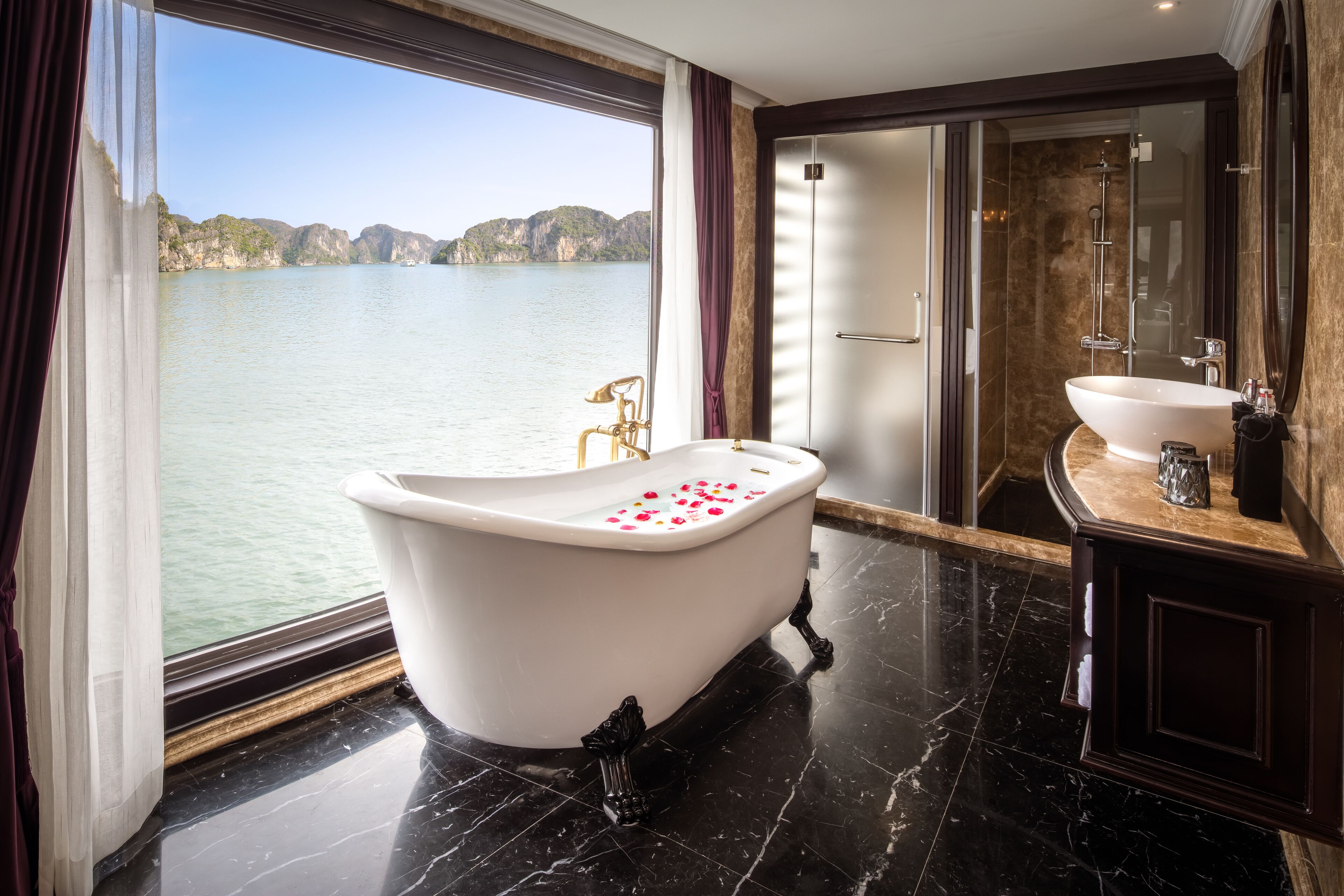 A bathroom with a freestanding bathtub, a shower, and a sink.