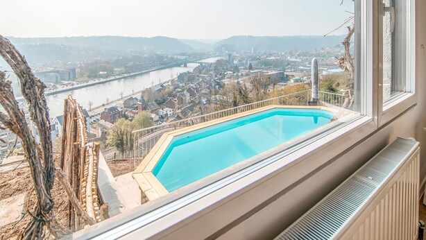 A view from a window with a pool, overlooking a river and a town. - Holiday Home in HUY Near Town Center (Wanze)