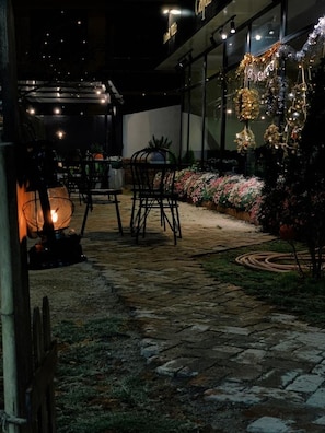 Relax in style on this inviting patio, complete with comfortable seating and lush greenery.