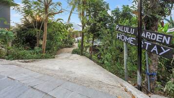 A pathway leading to a property named "Palulu Garden Home Stay."