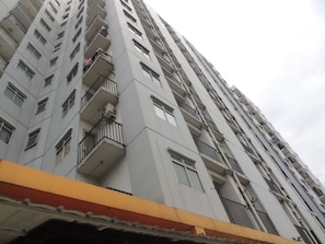 A high-rise building with multiple balconies, large windows, and a flat facade. - Alexandria Room at Apartement Paragon Village (Curug)