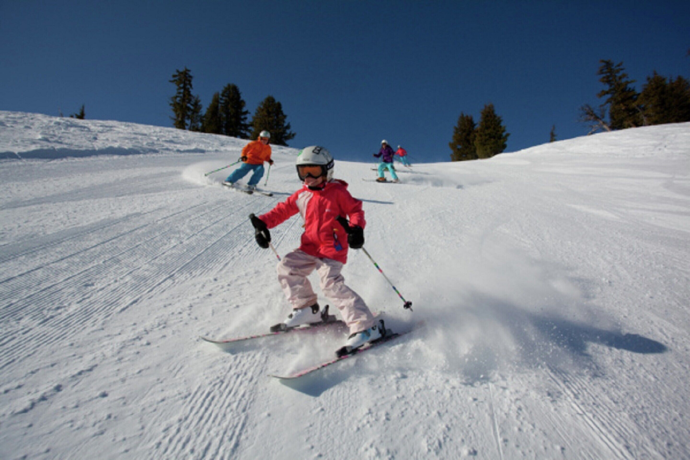 A snowy ski slope with skiers.