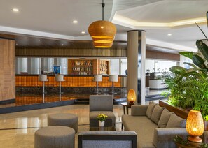 A modern lobby with a reception desk, seating area, and a bar. - Kaya Side Hotel (Manavgat)