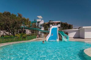 A swimming pool with a water slide and a lifeguard stand. - Kaya Side Hotel (Manavgat)