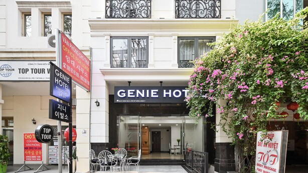 A hotel entrance with a sign for 'GENIE HOTEL' and a visible reception area.