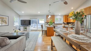 A modern kitchen with wooden cabinets, a central island, and a dining area with benches. - 5 Bedroom wine Country Home, Grill, Hot Tub, Granny unit in Santa Rosa  (Santa Rosa)