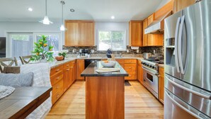 A modern kitchen with wooden cabinets, a stainless steel refrigerator, and a central island. - 5 Bedroom wine Country Home, Grill, Hot Tub, Granny unit in Santa Rosa  (Santa Rosa)