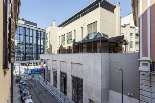 A multi-story building with a modern architectural design, featuring large windows and a flat roof.