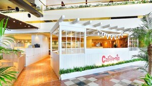 A hotel lobby with a reception desk, a 'WELCOME' banner, and a 'California' sign. - Tokyo Bay Maihama Hotel First Resort (Urayasu)