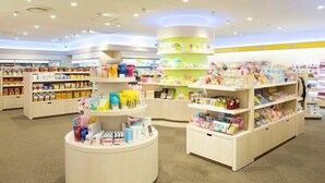 A brightly lit store with multiple shelves stocked with various products, including snacks and personal care items. - Tokyo Bay Maihama Hotel First Resort (Urayasu)