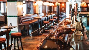 A bar area with stools, a bar counter, and a beer tap. - Hotel Bishops Arms Strangnas (Strängnäs)